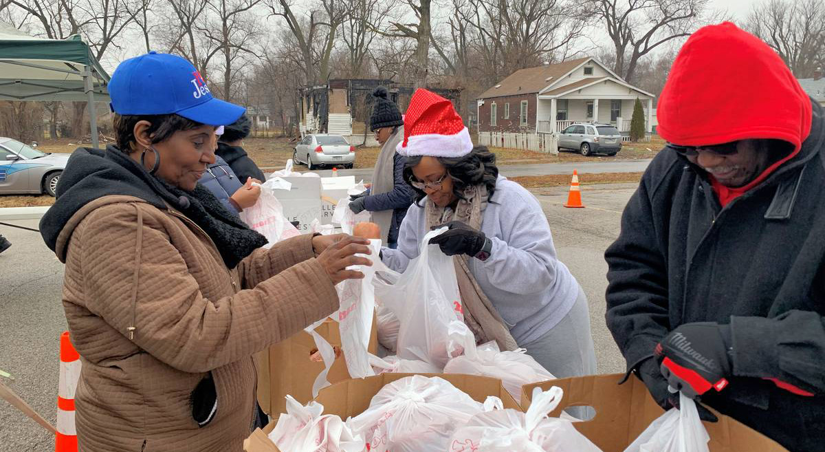 Volunteers pack fresh fruits and vegetables for walk-in and car-side deliveries.