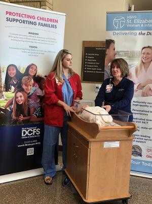 St. Elizabeth's nurses demonstrating how to safely put a baby to sleep. 