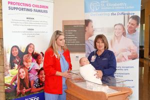 St. Elizabeth's nurses demonstrating how to safely put a baby to sleep. 